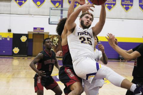 Columbia center Marcus Owens grabs a rebound in traffic against Chiles during Friday’s District 2-6A semifinal. (JORDAN KROEGER/Lake City Reporter)