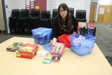 Emma Miles, Columbia County Library programs specialist, unpacks board and table-top games that will be featured in the library’s inaugural Teen Gaming League Night, set for 4-5 p.m. Wednesday. (TONY BRITT/Lake City Reporter)