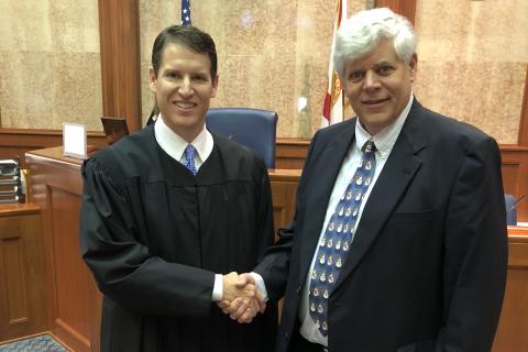 Interim Third Circuit State Attorney Dave Phelps shakes hands with Judge Mark Feagle after his swearing in December. (FILE)