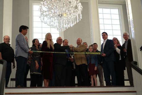 City officials and representatives of IDP Properties cut the ribbon during a ceremony Thursday afternoon at the Blanche’s main staircase.  (TONY BRITT/Lake City Reporter)