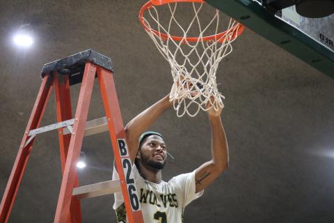 FGC guard Kenny Brown Jr. cuts down the nets after defeating Pasco-Hernando State College in the Divison II Region 8 championship on Saturday. (JORDAN KROEGER/Lake City Reporter)