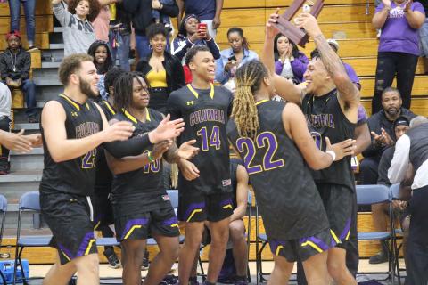Columbia's basketball team celebrates after defeating Lincoln to win the District 2-6A title on Saturday night.  (JORDAN KROEGER/Lake City Reporter)