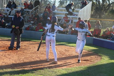 Columbia’s Anissa Penniman (12) high fives Zoryana Hughes after Hughes scored the game-winning run on a passed ball against Lafayette on Friday. (JORDAN KROEGER/Lake City Reporter)