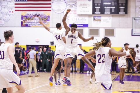 Columbia forward Marcus Peterson (1) celebrates with guard Amare Ferrell (14) after the Tigers beat Daytona Beach Mainland in last Friday’s Region 1-6A final. (BRENT KUYKENDALL/Lake City Reporter)