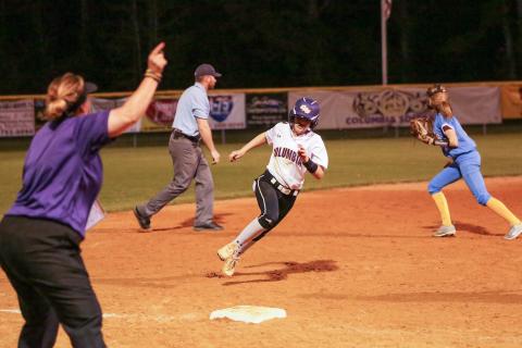 Columbia coach Trudy Andrews waves home Morgan Hoyle as she heads toward third base against Chiefland on March 10. (BRENT KUYKENDALL/Lake City Reporter)