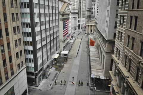 A lone pedestrian wearing a protective mask walks past the New York Stock Exchange as coronavirus concerns empty a typically bustling downtown area in New York on Saturday. (AP FILE PHOTO)