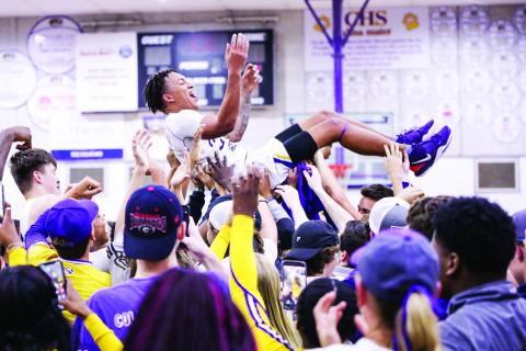 Columbia guard Jordan Smith is lifted up by students and teammates after the Tigers defeated Daytona Beach Mainland 70-65 in last Friday's Region 1-6A final. (BRENT KUYKENDALL/Lake City Reporter)