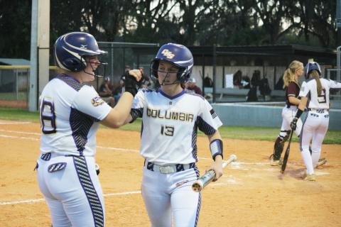 Columbia catcher Reece Chasteen celebrates with third baseman Morgan Hoyle after Hoyle scores in the first inning against Madison County on Thursday night. (JORDAN KROEGER/Lake City Reporter)