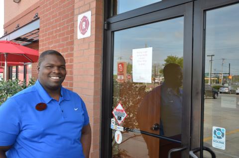 Travis Tomlin, an employee at the Lake City Chick-fil-A, stands outside the business, which has closed off its dining area to customers and gone to drive-through-only service. Other fast food chains are doing the same. (CARL MCKINNEY/Lake City Reporter)
