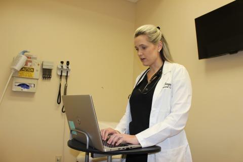 Lyndsey Jones, APRN at Baya Urgent Care in Lake City, speaks with a patient via a TeleMedicine video call Tuesday afternoon. The company launched the video chat service to ease patients’  fears over COVID-19 and give them a safe option for treatment without being exposed to others in waiting rooms at clinics and doctor’s offices.                   The service also provides a safe option for a question screening for people who fear they may have the COVID-19 coronavirus. (TODD WILSON/Lake City Reporter)