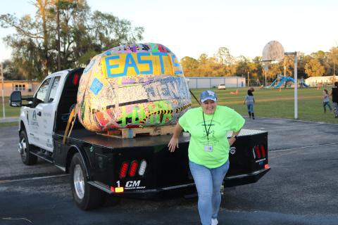 Pamela Hartopp, the Eastside Elementary paraprofessional who spearheaded the effort, poses for a picture with a 1,310 lb. ball of tape. That’s 690 pounds short of the current world record, so they’ll get back at it Saturday. (TONY BRITT/Lake City Reporter)