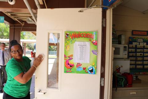 Scharlotte Stewart, Eastside Elementary School head custodian, disinfects a kindergarten classroom door on Thursday morning. The school district will have some of its employees clean and disinfect classrooms for two days next week while students and teachers are on spring break. (TONY BRITT/Lake City Reporter)