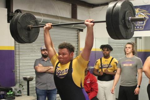 Columbia’s Nate Walsmley finishes his clean and jerk during Wednesday’s meet against Buchholz. Walmsley won the heavyweight class with a 600-pound total. (JORDAN KROEGER/Lake City Reporter)