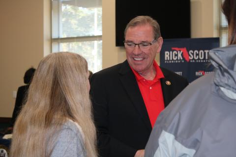 U.S. Rep. Neal Dunn chats with Rebecca Presnell, who, at 14, has already started the process of meeting admission requirements of the U..S Naval Academy. (AMY HIETT/Special to the Reporter)