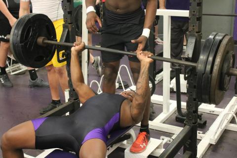 Columbia’s Marlon Pollock bench presses during a meet on March 11. (JORDAN KROEGER/Lake City Reporter)