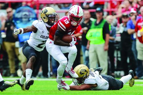 Nebraska Cornhuskers receiver Mike Williams escapes a tackle from Colorado Buffaloes defensive back Evan Worthington while defensive back Ronnie Blackmon attempts to make a tackle at Memorial Stadium on Sept. 8, 2018, in Lincoln, Neb. (MICHAEL SPOMER/Cal Sport Media via AP)