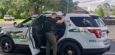 Cpl. Shane Foote of CCSO is seen speaking to a suspect after his capture. (COURTESY CCSO)