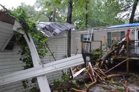 A local mobile home took a beating early Wednesday morning, after a storm rolled through the area and knocked a tree or two onto the structure. The residents took shelter in a bathroom, emerging shaken but safe. (CARL MCKINNEY/Lake City Reporter)