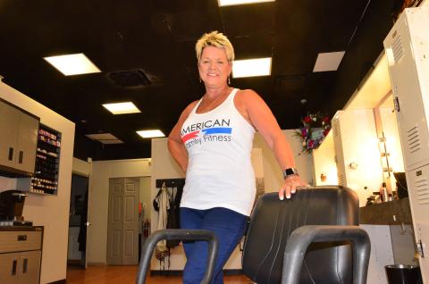 Lisa Waltrip, owner of Haircuts Unlimited in Village Plaza, is seen in her shop Thursday. Despite a state order, she remains open for business, accepting daily appointments for haircuts. (CARL MCKINNEY/Lake City Reporter)