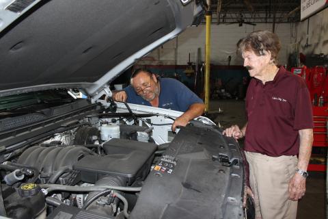 Lake City Tire Company owner Al Rollison, right, discusses an engine repair with lead technician Jim Givens Tuesday afternoon in the downtown auto repair shop.                    Rollison said for locally owned small business to survive, Lake City residents need to shop with each other. The store can be reached at (386) 752-6614. (TODD WILSON/Lake City Reporter)