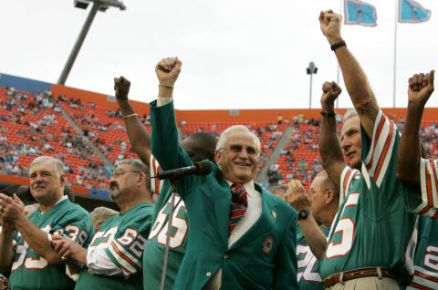 Former Miami Dolphins head coach Don Shula, center, waves with former players from the 1972 unbeaten team during a ceremony at a football game against the Baltimore Ravens at Dolphin Stadium on Dec. 16, 2007, in Miami. From L-R: Running back Larry Csonka (39), center Jim Langer (62) and linebacker Nick Buoniconti, right. (LYNNE SLADKY/Associated Press)