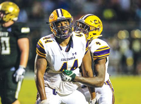 Columbia defensive lineman Terrick Ponds (44) is congratulated by linebacker Le’vontae Camiel (4) after a tackle for loss against Oakleaf on Aug. 30, 2019. (FILE)