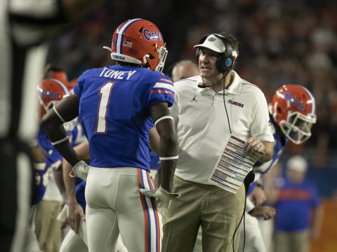 Florida head coach Dan Mullen, right, talks to Kadarius Toney during the Capital One Orange Bowl against Virginia at Hard Rock Stadium on Dec. 30, 2019, in Miami Gardens. (AL DIAZ/Miami Herald/TNS)