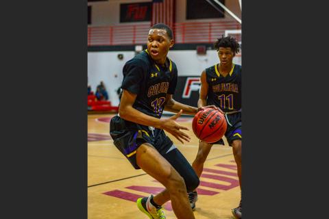 Columbia forward D’Andre Jefferson turns to drive to the basket against Fort White on Dec. 13, 2019. (THOMAS RICKS/Special to the Reporter)