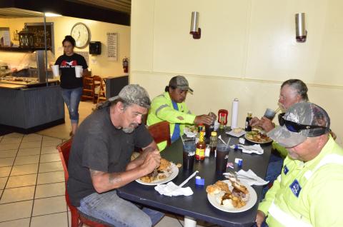 Workers with a local construction company enjoy their first dine-in meal in weeks late Monday morning at the Landing, a family buffet off U.S. 90. Pictured on the front left is Greg Walker, who is joined by Nicholas Flick at right, Aureliano San Juan in the back left and Danny Boone in the back right. (CARL MCKINNEY/Lake City Reporter)