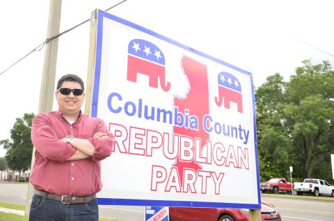 Columbia County GOP Chairman Hunter Peeler poses in front of the local Republican headquarters. The 21-year-old has been chosen to be a delegate at the Republican National Convention in North Carolina this August. (CARL MCKINNEY/Lake City Reporter)