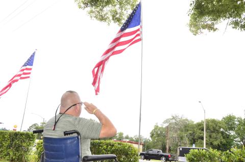 Larry Carter, a retired Army airborne infantryman, salutes the flag on Memorial Day outside the Lake City VA hospital. (CARL MCKINNEY/Lake City Reporter)