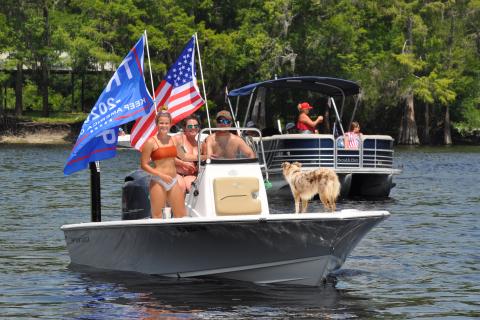 Trump supporters Cayden Taylor, Jarrod Taylor, Heather Spahalski and Paisley the dog participate in a river rally for the president Sunday. Boat rallies are a new fad dubbed the “Trumptilla.” (JEN STRICKLAND WILLIAMSON/Special to the Reporter)
