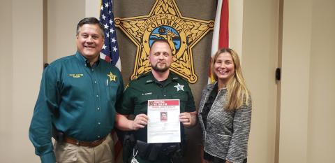 From left are Sheriff Mark Hunter, Deputy Chris Alford and Jacksonville FBI Special Agent In Charge Rachel Rojas. (COURTESY CCSO)