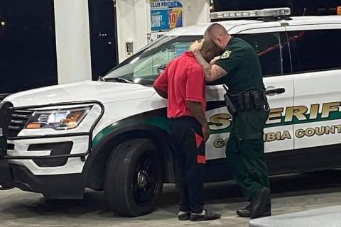 Deputy Chris Alford comforts a young man after an encounter with racists at a local store. (COURTESY CCSO)