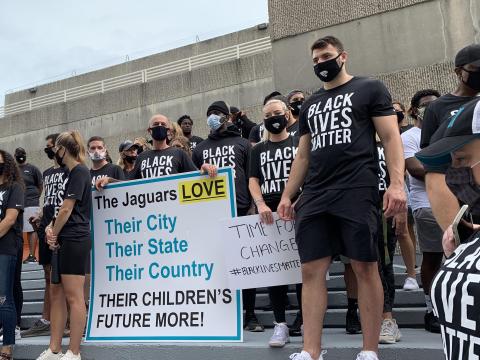Members of the Jaguars organization, including rookie tight end Tyler Davis (right) stand on the steps of the Jacksonville Sheriff's Office during a peaceful protest on Friday. (TRIBUNE NEWS SERVICE)