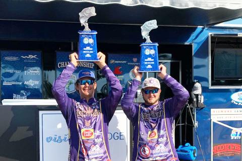 Columbia High Bassmasters Seth Slanker (left) and Jackson Swisher (right) raise their trophies after winning the Florida Bass Nation State Championship on Sunday. (COURTESY)