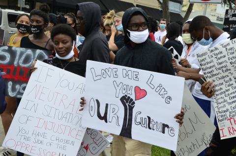 Demonstrators wave signs at traffic on U.S. 90 during a Black Lives Matter rally Friday afternoon. More than 150 people participated in a march along major roads in Lake City. (CARL MCKINNEY/Lake City Reporter)