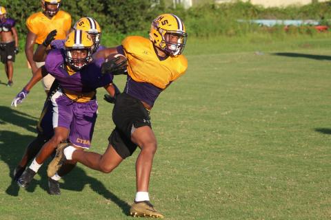 Columbia running back Jailen Brown rushes up the field as defensive back Dante Brown gives chase during a practice last August. (FILE)