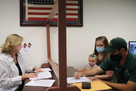 Lori Koon (clockwise from left), deputy clerk, helps Anna Marlowe, Vera Platt and Donald Platt as they complete an application for a marriage license while at the Columbia County Clerk of Courts Record Division Office on Wednesday. Due to budget cuts, the clerks office is now closed on Fridays. (TONY BRITT/Lake City Reporter)