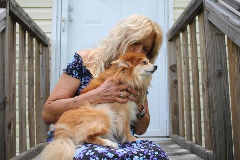 Brenda Brickel, a local registered nurse, holds Teddy Weddy Bear, her eight-pound Pomeranian that woke her Tuesday night when she feel asleep while cooking chicken wings. Brickel credits the dog with saving her life. (TONY BRITT/Lake City Reporter)
