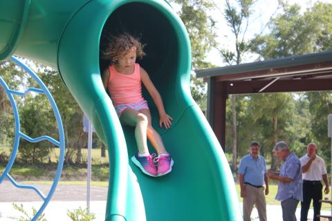 Sailor Hunter, 4, has a ‘hair-raising’ experience as she takes a ride down the sliding board Friday morning at the Columbia City Park. The park, which is fully compliant with the American Disabilities Act, is the county’s first fully inclusive playground. (TONY BRITT/Lake City Reporter)