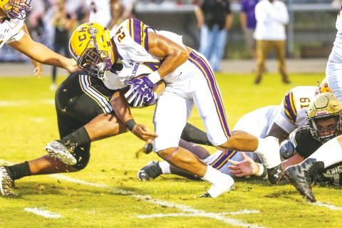 Columbia running back Jailen Brown (24) runs through a tackle against Oakleaf on Aug. 30, 2019. (GARY LLOYD MCCULLOUGH/Special to the Reporter)