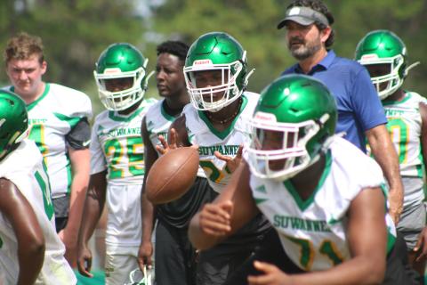 Suwannee quarterback Malachi Graham eyes the snap during drills in practice Tuesday. The Bulldogs began fall practice Monday, the first day allowed by the FHSAA. (JAMIE WACHTER/Lake City Reporter)