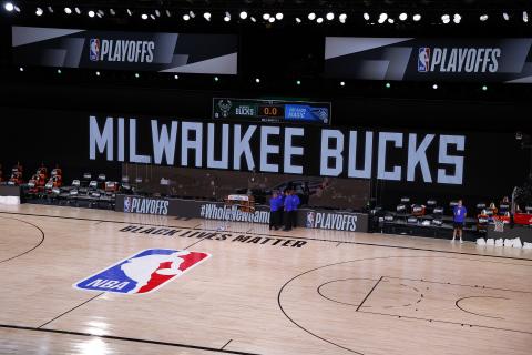 Referees huddle on an empty court at game time of a scheduled game between the Milwaukee Bucks and the Orlando Magic for Game 5 of the Eastern Conference first round series atAdventHealth Arena at ESPN Wide World Of Sports Complex on Wednesday, in Lake Buena Vista. The Bucks boycotted the game to protest the police shooting of Jacob Black. (KEVIN C. COX/Getty Images/TNS)