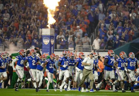 Florida Gators head coach Dan Mullen leads his team onto the field at the Orange Bowl at Hard Rock Stadium on Dec. 30, 2019, in Miami Gardens. (ALLEN EYESTONE/The Palm Beach Post/TNS)