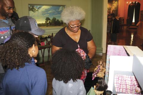 Shirley Marshall talks about her doll collection with guests during a diorama at the Stephen Foster Folk Culture Center State Park. Marshall owns more than 600 dolls, including more than 300 black dolls. (FILE)