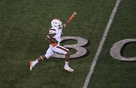 Miami Hurricanes running back Jaylan Knighton runs for a touchdown in the third quarter against Louisville at Cardinal Stadium Saturday night, in Louisville, Ky. Miami won, 47-34. (ANDY LYONS/Getty Images/TNS)