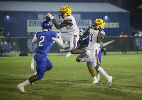 Columbia wide receiver Jaden Williams hauls in a pass in front of Trinity Christian defensive back Christian Ellis on Friday night. (BRENT KUYKENDALL/Lake City Reporter)