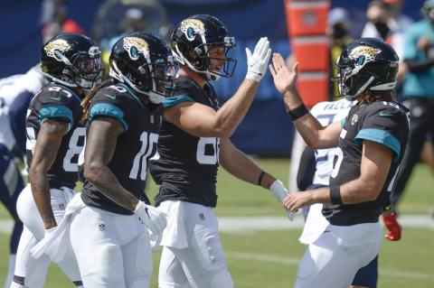 Jacksonville Jaguars tight end Tyler Eifert (88) is congratulated by quarterback Gardner Minshew, right, after teaming up for a 19-yard touchdown pass against the Tennessee Titans on Sept. 20, 2020, in Nashville, Tenn. (MARK ZALESKI)
