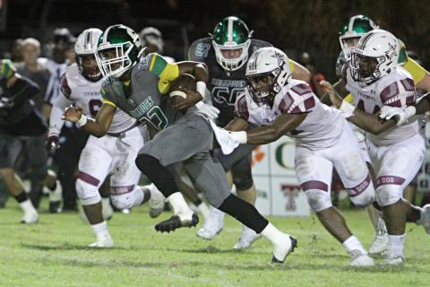 Suwannee running back Malachi Graham tries to pull away from a Madison County defender Friday night at Langford Stadium. (PAUL BUCHANAN/Special to the Reporter)